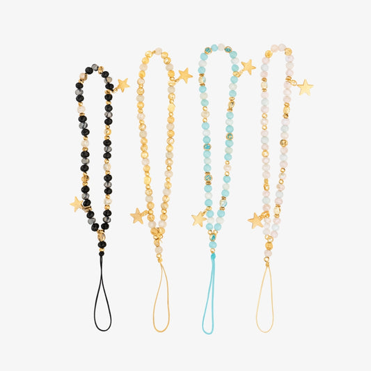 Four beaded phone charms in black, gold, light blue, and light pink, each embellished with small gold star pendants and a matching bottom loop